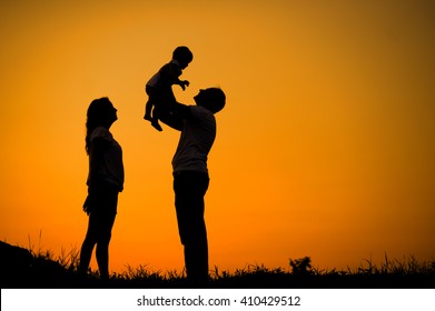 Silhouette happy young family on sunset background - Powered by Shutterstock