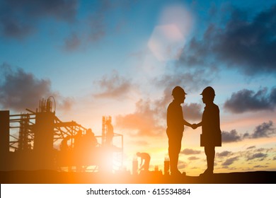 Silhouette The Head Of A Large Engineering Company Joins With Small Companies And Jointly Build Large Structures Over Blurred Sky.