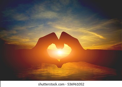 silhouette heart shape with hands on sunset,Silhouette hands making a heart shape,Heart concept, the concept of good health work. - Shutterstock ID 536961052
