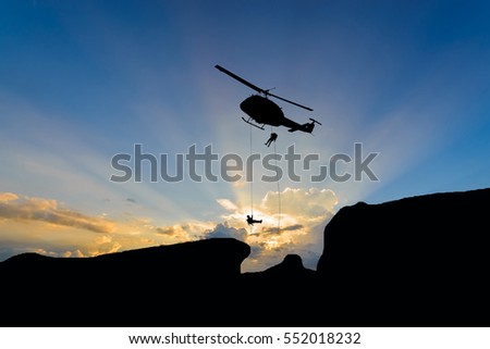 silhouette of helicopter with sunset.