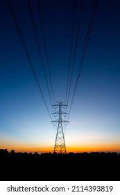 Silhouette High Voltage Electric Transportation.High voltage transmission pole against sunset background. - Shutterstock ID 2114393819