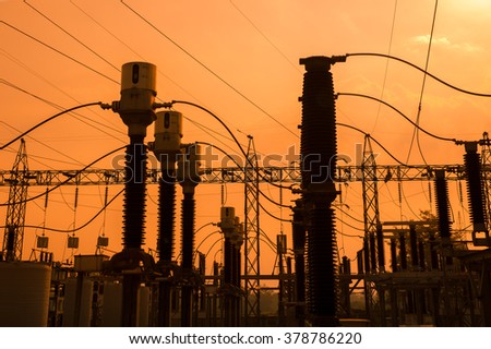 Silhouette of High voltage power plant and transformation station at sunset