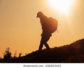 Silhouette of Hiker Tourist Woman With Backpack During Mountain Trekking - Powered by Shutterstock