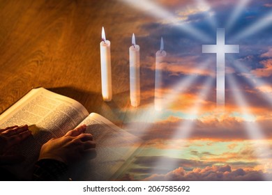 Silhouette holy cross. Praying hands on bible. holy cross as a symbol of Christianity. Catholic is praying next to the candles. holy bible on a wooden table. Orthodox religion symbol.