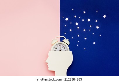 Silhouette of human and alarm clock on pink and blue backgrounds decorated with silver confetti. Human circadian rhythms concept. Copy space - Shutterstock ID 2122384283