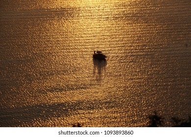 Silhouette Of Human And Boat In Golden Water At Lake Travis, Austin, Texas - May 7,2018.