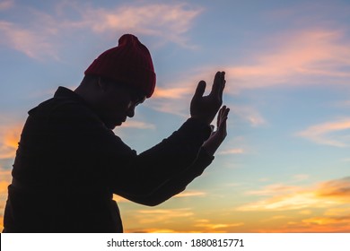 Silhouette human praying to the GOD with bright sunbeam sky - Shutterstock ID 1880815771