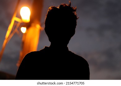 Silhouette Of Human Subject With Source Light Background