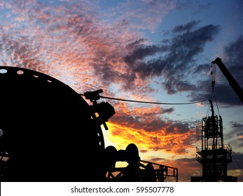 Silhouette Image Of Coiled Tubing Unit During Servicing Oil And Gas Well After Well Stimulation Program In Unconventional Reserve