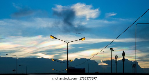 Silhouette image of street lamp poles and telephone poles against twilight at dusk or evening. - Powered by Shutterstock