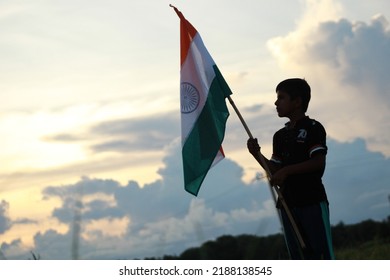 Silhouette Of A Indian Boy Holding The Indian Tricolour Flag Celebrating The Independence Day.