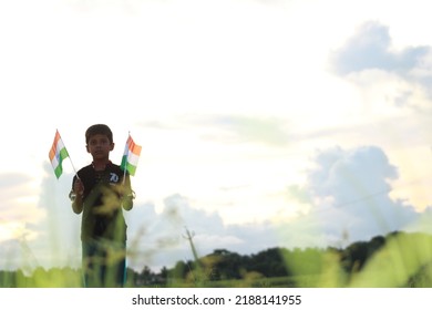 Silhouette Of A Indian Boy Holding The Indian Tricolour Flag Celebrating The Independence Day.