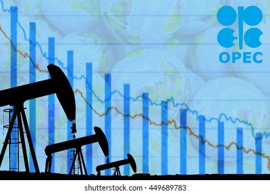 silhouette industrial oil pump jack and falling oil graph on the blue globe background