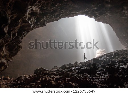 A silhouette inside the beautiful cave Goa Jomblang in East Java, Indonesia