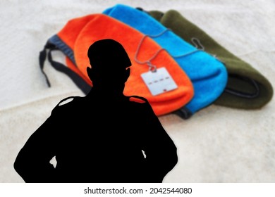 Silhouette of an Israeli soldier, IDF Soldier, on a blurred background with a soldier's berets of various types of troops in Israel and soldier's medallion (badge) 