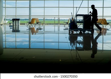 Silhouette Of Janitor Cleaning Service Male Guy On Duty In Artistic Shot