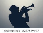 silhouette of a jazz man playing trumpet