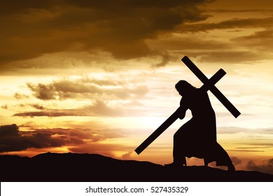 Silhouette of Jesus carry his cross on the hill