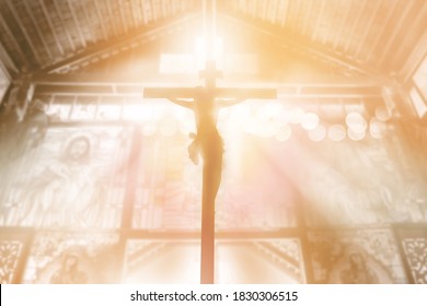 Silhouette Jesus Christ Crucifixion On Cross Over Orange Sunset Light Inside Church Background, Prayer And Praise Religion Concept