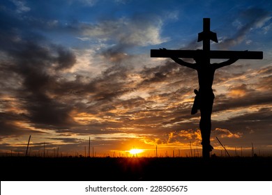 Silhouette Jesus Christ crucifixion on cross over calvary sunset background concept for he is risen in easter day, good friday jesus death on crucifix, world christian happy and holy spirit religious.