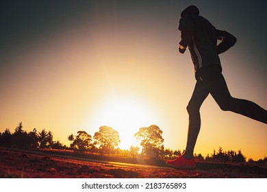 Silhouette of a Kenyan runner at sunrise. Photo from marathon training with edit space - Shutterstock ID 2183765893