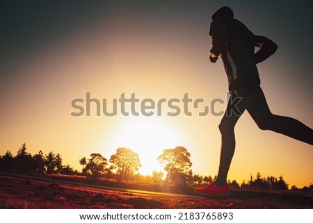 Silhouette of a Kenyan runner at sunrise. Photo from marathon training with edit space