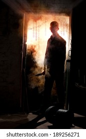 Silhouette Of Killer, Standing With Knife In His Hand Against Smoke