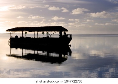 Silhouette Landscape View Polynesian Boat Mooring On Muri Lagoon At Dawn In Rarotonga Cook Islands.