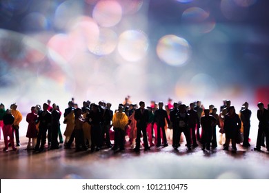 Silhouette of a large group of unrecognizable people. High contrast mob, squad, or crew of men and women. Big crowd or team on white with space for text. High contrast miniature photo.