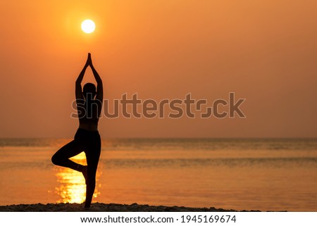 Silhouette lifestyle woman yoga exercise healthy life.  Young girl or people pose balance body vital zen and meditation workout and fitness sport outdoor sunset near the beach. Sea background.