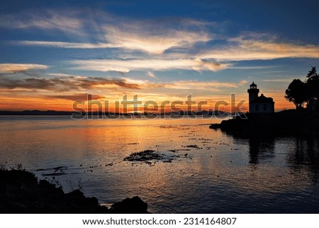 A silhouette of the Lime Kiln Lighthouse at sunset in San Juan County, Washington