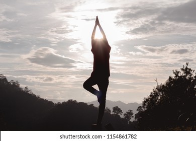 Silhouette of little girl playing yoga at sunset - Powered by Shutterstock