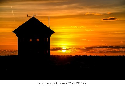 Silhouette of a lonely house against the sunset. Lonely house at sunset. Sunset house view. House at sunset
