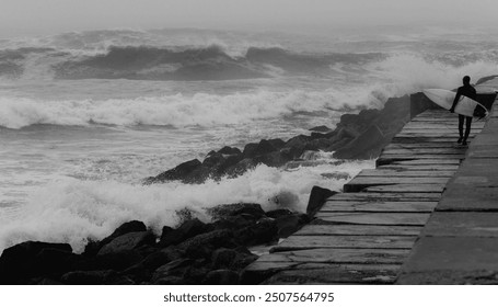 silhouette of lonely surfer standing by the stormy ocean  - Powered by Shutterstock