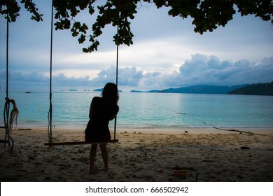 Silhouette Lonely Woman Watching The Blue Sea Alone On The Beach.