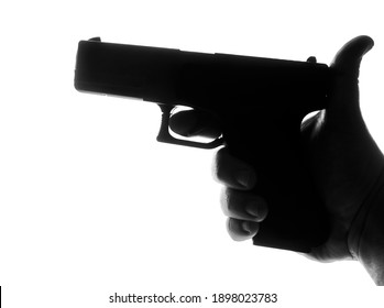 Silhouette Of Male Hand Holding Gun Isolated On White Background. Silhouette Of  Black Pistol. Finger On The Trigger Of The Gun