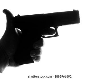 Silhouette Of Male Hand Holding Gun Isolated On White Background. Silhouette Of  Black Pistol. Finger On The Trigger Of The Gun