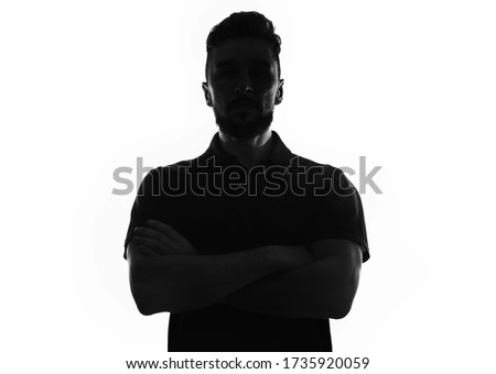 Silhouette of male person with arms crossed over white