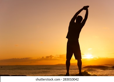 Silhouette Of Male Stretching Outdoors. (location Hawaii)