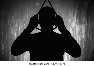 Silhouette of male suicider going to hang himself against grunge background