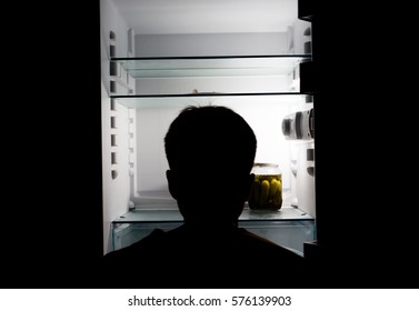 Silhouette Of A Man About An Empty Fridge.