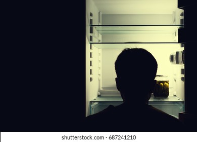 Silhouette Of A Man About An Empty Fridge.