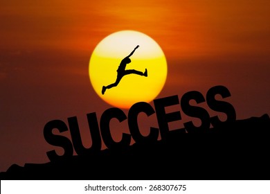 Silhouette man celebrate his success by jumping on the hill at sunset time