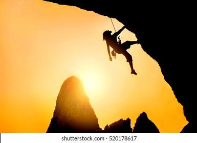 Silhouette Of Man Climbing At Sunset. Extreme Sport Concept. Rock Climbing In Thailand