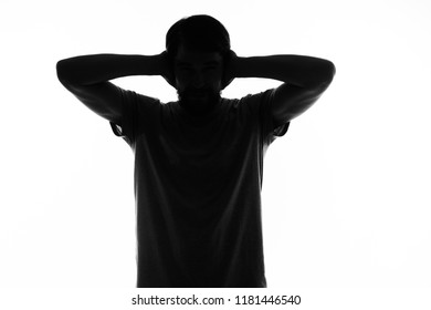 silhouette man covered his ears with his hands                    