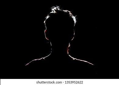 silhouette of man in dark place, anonymous backlit contour - Powered by Shutterstock