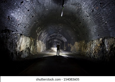 Silhouette Of Man In A Dark Tunnel