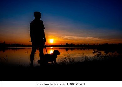 Silhouette of man and dog on sunset background. - Powered by Shutterstock