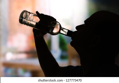 Silhouette Of Man Drinking Alcohol, Close Up