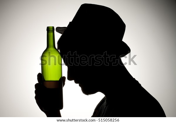 Silhouette Man Drinking Wine Bottle Smoking Stock Photo - 